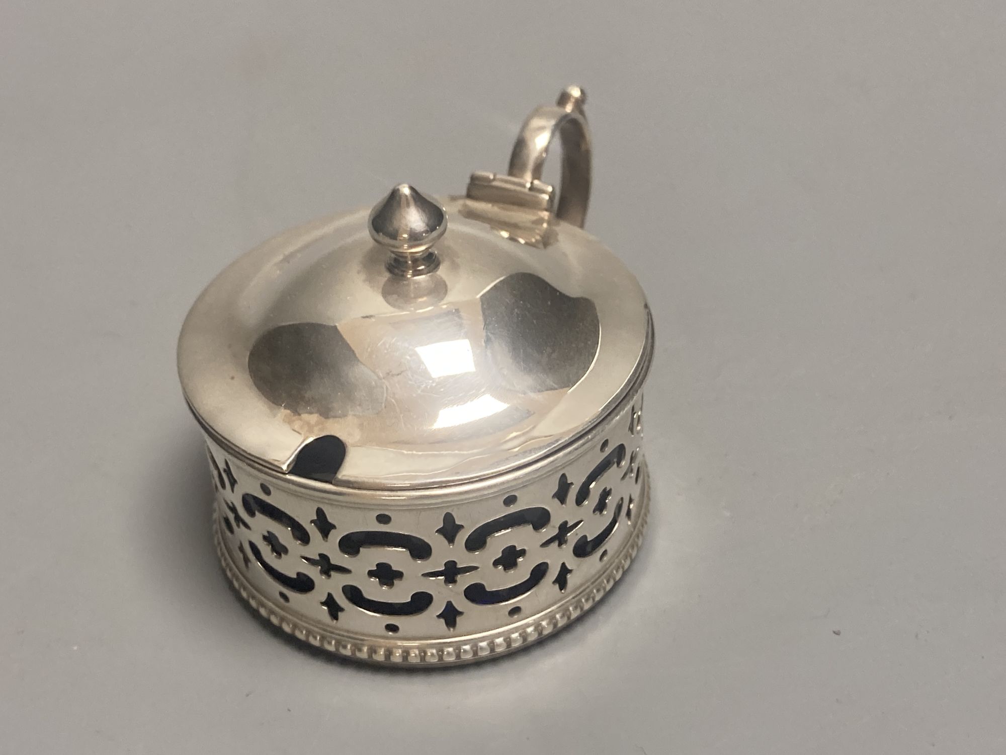 A late Victorian demi fluted silver mustard pot, London, 1894 and four other assorted later silver mustards.